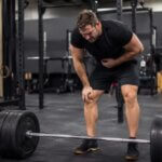Athlete recovering after a heavy deadlift set and feeling nauseous