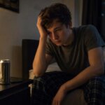 Person lying awake in bed at night after drinking an energy drink