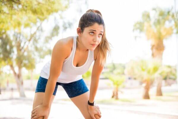 Runner feeling weak and exhausted after running in a park