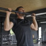Athlete experiencing head pressure during a pull-up in a gym