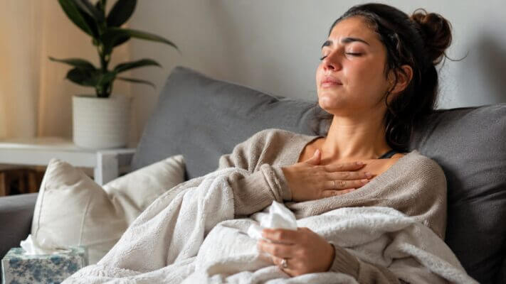 Woman calming down after crying with hand on chest