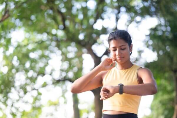 Runner checking a fast heartbeat after a run