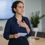 Person holding presentation notes before speaking to an audience
