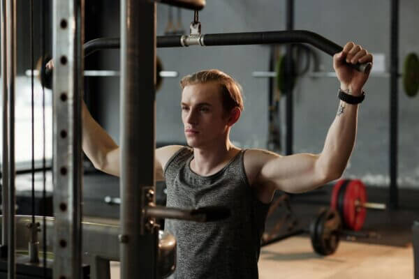 Athlete performing a cable pulldown exercise during a strength workout