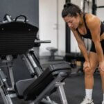 Person recovering after a heavy leg press set at the gym