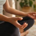 Person noticing mild shakiness after a meditation session at home
