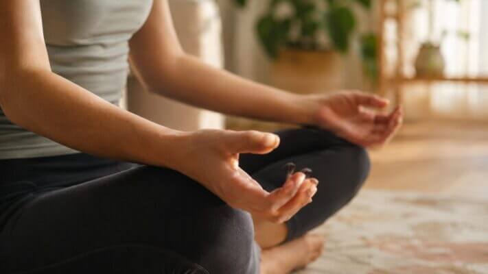 Person noticing mild shakiness after a meditation session at home