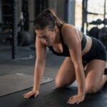 Person pausing during mountain climbers after feeling nauseous during a workout
