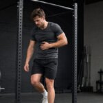 Athlete feeling nauseous after a hard pull-up set in the gym
