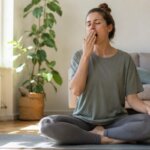 Person feeling sleepy after a meditation session in natural morning light