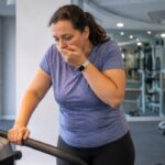 Person feeling nauseous while walking on a treadmill in a gym
